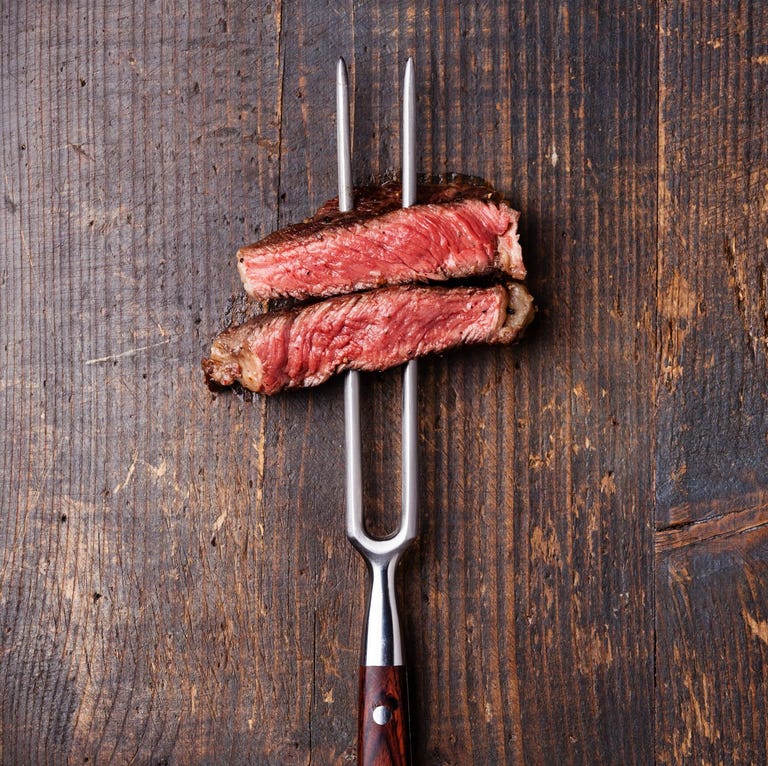 Slices of Steak Ribeye on meat fork