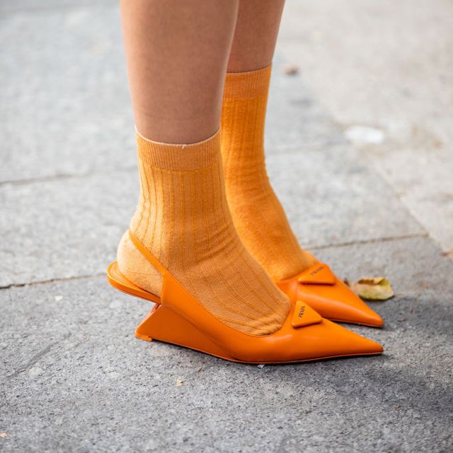 paris, france   june 22 a guest is seen wearing orange socks, prada heels outside rhude during paris fashion week   menswear springsummer 2023 on june 22, 2022 in paris, france photo by christian vieriggetty images