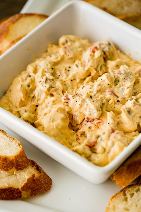 slow cooker dips cheesy slow cooker sausage dip in white bowl with bread slices