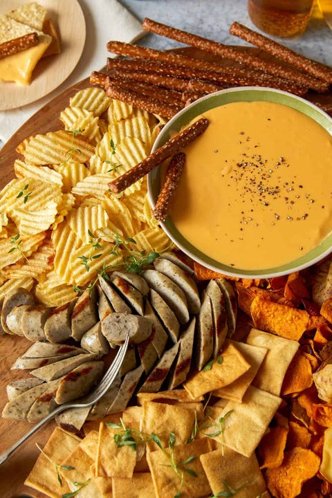 slow cooker dips crock pot beer cheese dip with potato chips and sliced sausages