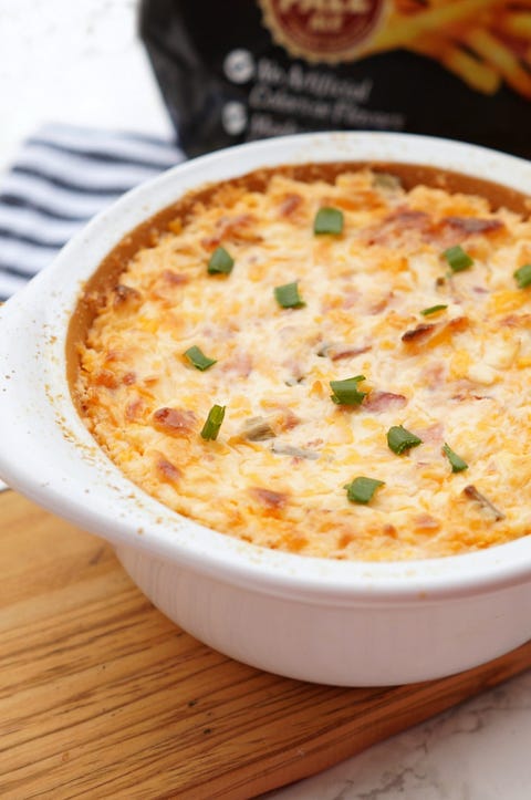 loaded baked potato dip in white bowl