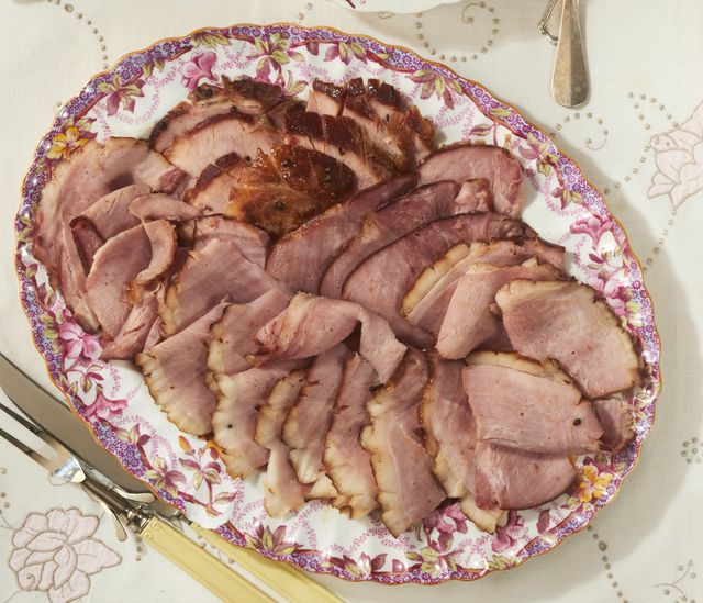 slow cooker ham on platter with easter side dishes