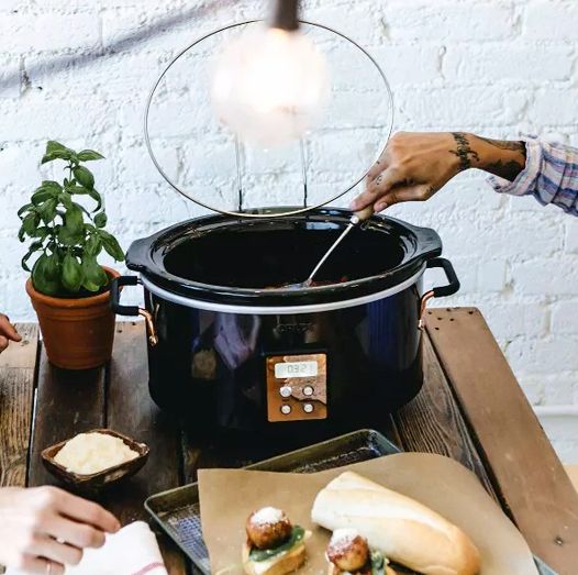 women using a crux slow cooker to make meatballs