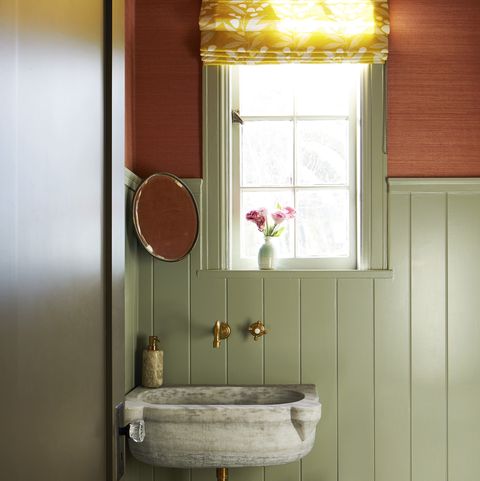 los angeles home designed by fran keenan earthen hues shine in the powder room with mossy wainscot paneling pigeon by farrow ball and a luminous terra cotta abaca wallcovering phillip jeffries