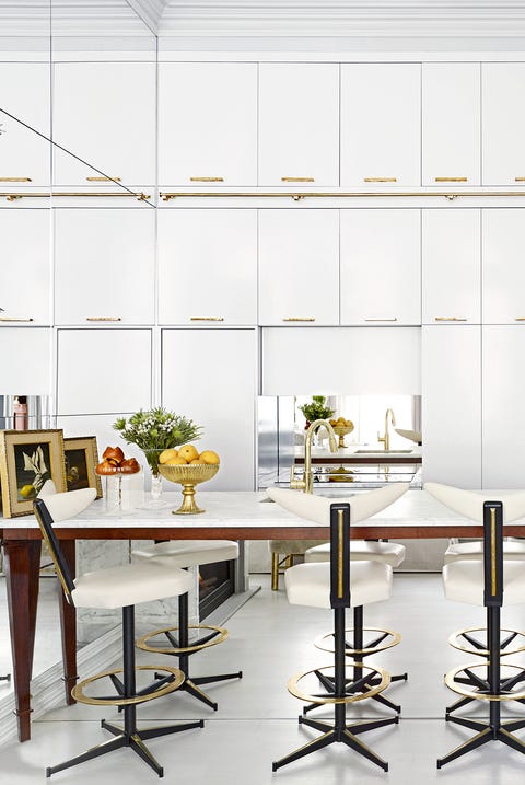 small white kitchen with hanging pots