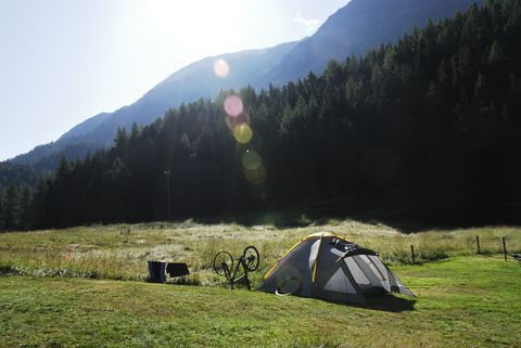 a small tent and a bike in a field in st moritz
