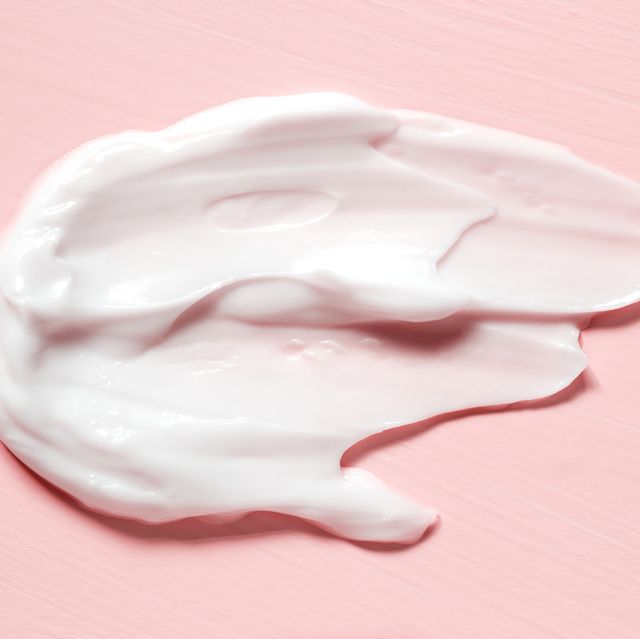 smear of natural moisturizer in pink background cream lotion for face or body skin care