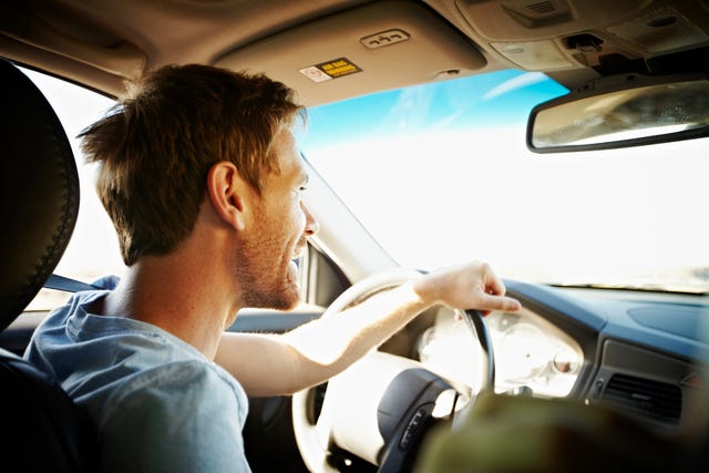 smiling man driving car