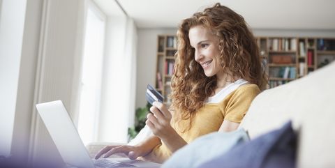Smiling woman at home shopping online