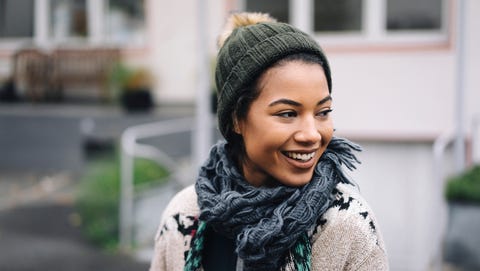 Smiling young woman wearing wooly hat outdoors Smiling young woman wearing wooly hat outdoors
