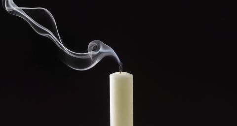 smoke trailing from extinguished white candle