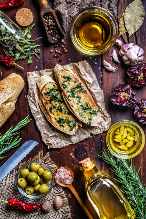 snack or appetizer of garlic basil and olive oil bruschetta on table in a rustic kitchen