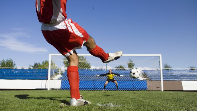 a soccer player taking a penalty shot