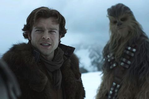 solo a star wars story alden ehrenreich as han solo, standing in the snow with chewbacca joonas suotamo
