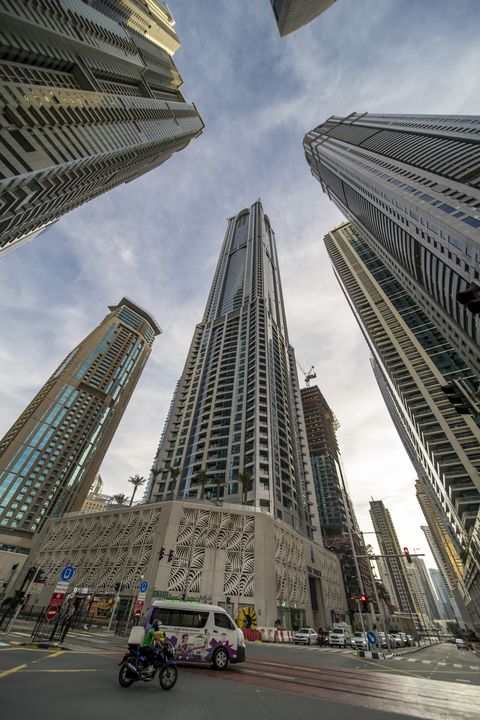 some of the world's tallest residential buildings tower over traffic underneath in the dubai marina