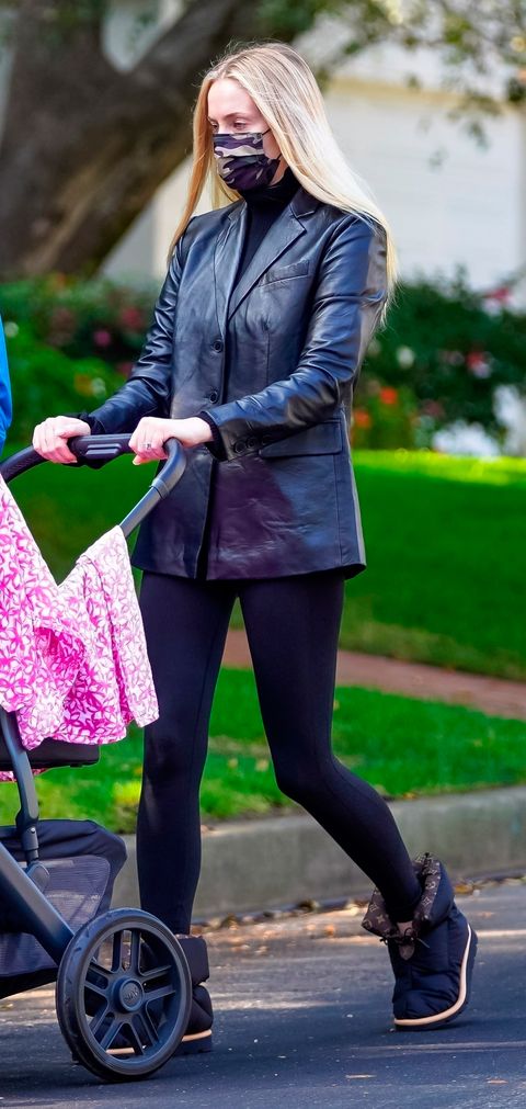 fe Tibio Contiene Sophie Turner con chaqueta de Mango, leggins y botas negras