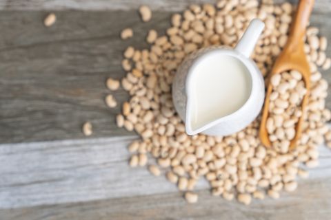 soy milk and soy bean on wooden background