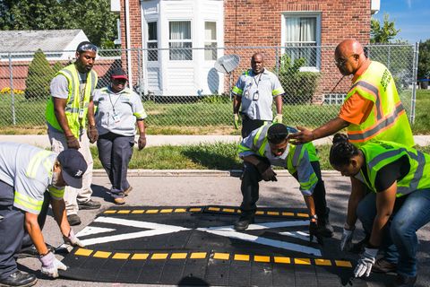 workers installing speed humps in detroit