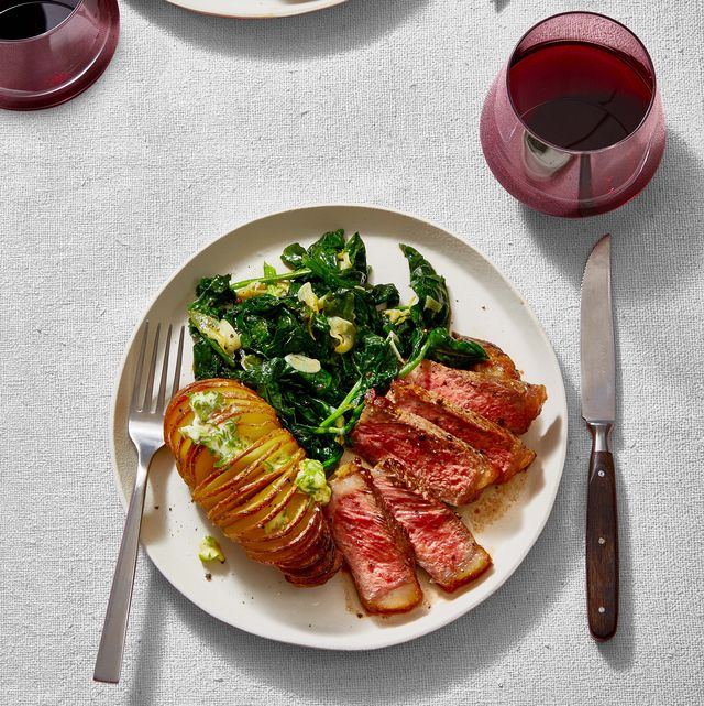 ny strip steak, garlicky sauteed spinach, and roasted hasselback potatoes with scallion butter for valentines day dinner