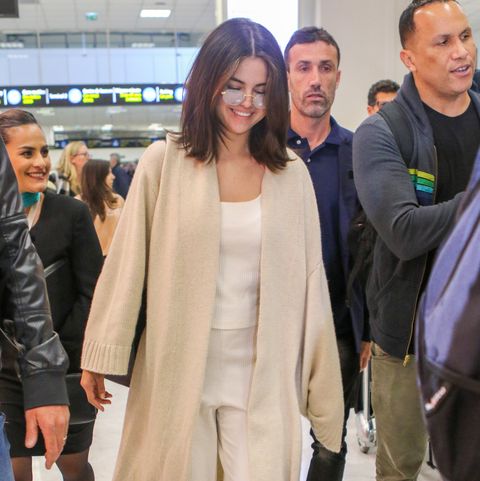 Selena Gomez Wore a Cream Cardigan and White Jumpsuit in the Nice Airport
