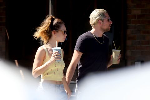 lily james and michael shuman hold hands while drinking smoothies