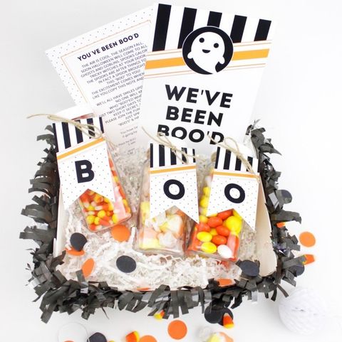a spooky basket with the theme of ghosts, featuring jars that are labeled b o o