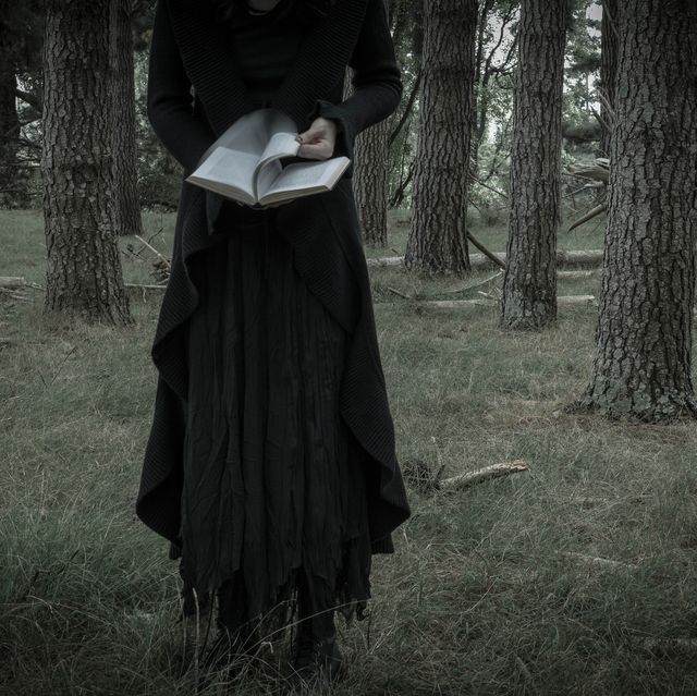 Bizarre Woman Reading A Book In The Forest