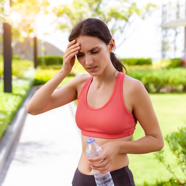 sport woman thirsty dehydrated in hot weather dehydration, overheating, thirst, heat stroke, health care concept with girl in strong sunny day she get dizzy, fainting after running outdoors in summer