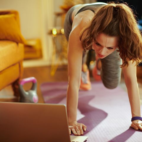 sports woman using online streaming fitness site