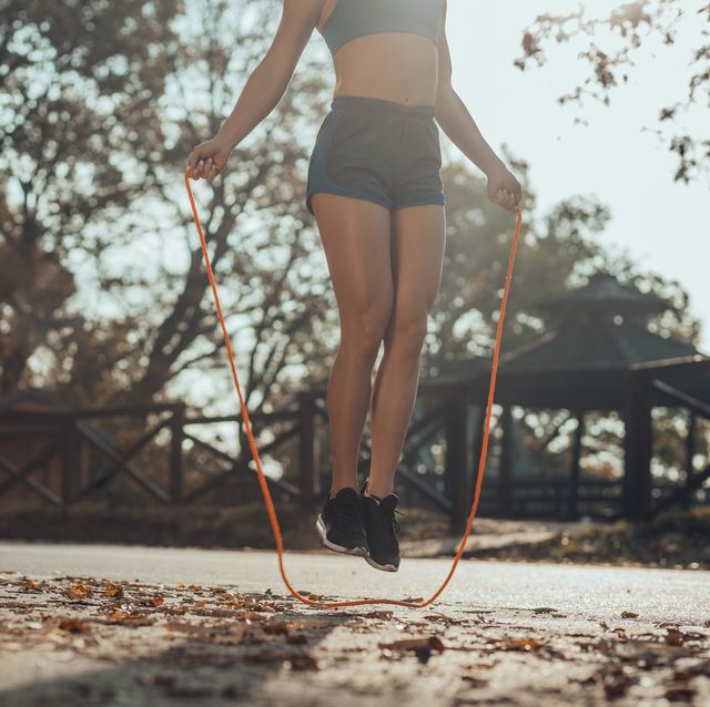 sportswoman exercising with skipping ropes