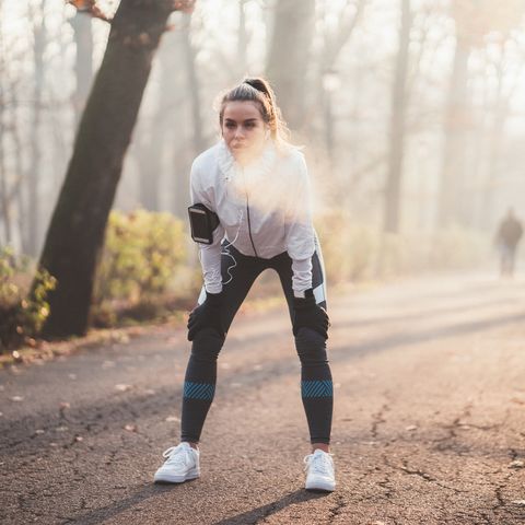 Sportswoman taking a breath after jogging