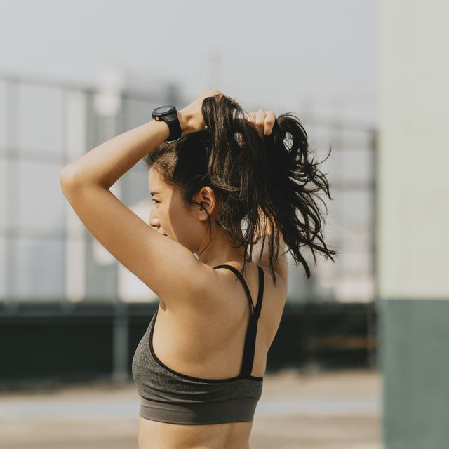 sportswoman tying hair into a ponytail before the workout