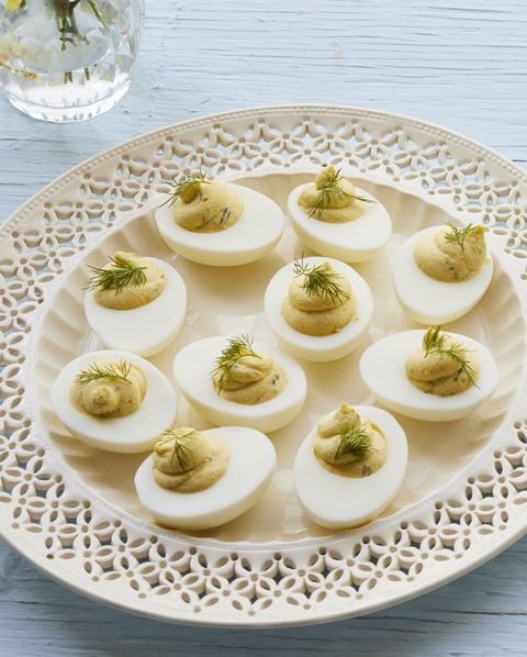whipped deviled eggs with dill on white plate