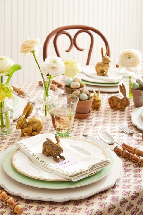 brass bunnies used as a centerpiece on a set table