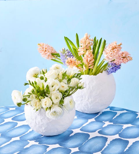 white vases made from paper mache filled with spring flowers