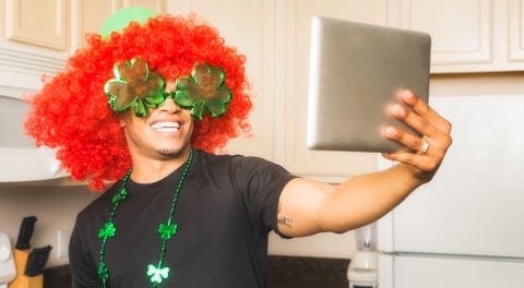 man in wig taking selfie