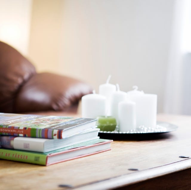 stack of books with a tray of candles on table