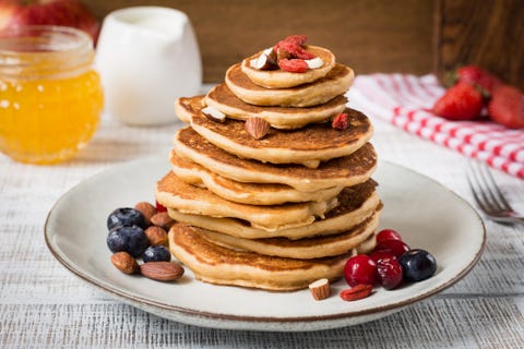 Stack of pancakes with berries and nuts pancakes with whey protein