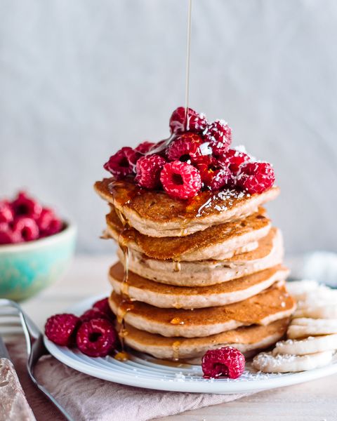 stack of raspberry and maple syrup pancakes