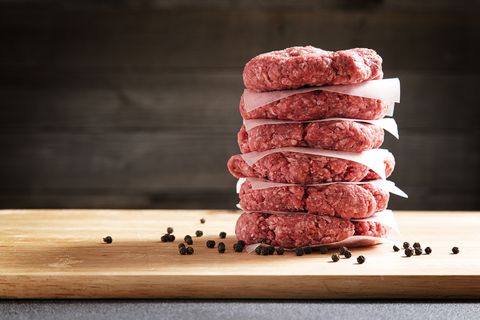stack of six raw burgers