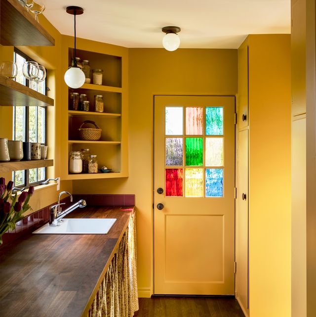 yellow kitchen with stained glass window