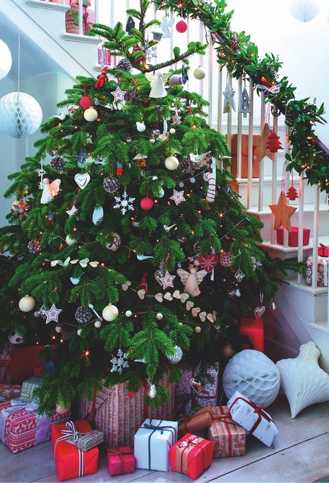 Christmas tree in entrance hall create a stunning entrance with a dramatic tree and add impact with baubles hung around the staircase7ft nordmann fir christmas tree, from