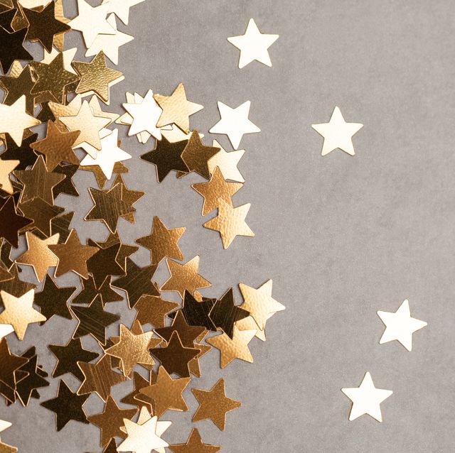 star shaped confetti on gray background illuminating new year backdrop