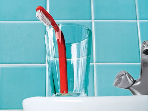 Toothbrush in cup on a sink