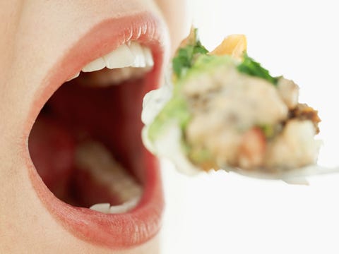 Mistake: You take big bites. Woman having a large bite of food