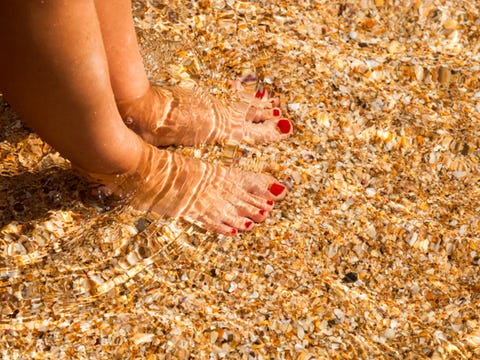 Woman's feet in shallow water