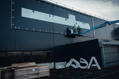 an old psa group logo beneath workers in a cherry picker to prepare an led base for a new stellantis nv logo at the automakers technical center in velizy villacoublay near paris, france, on monday, jan 18, 2021 stellantis, the carmaker formed from the merger of fiat chrysler automobiles nv and psa group, advanced in its first day of trading after completing a more than two year effort to form one of the worlds largest vehicle manufacturers photographer cyril marcilhacybloomberg via getty images