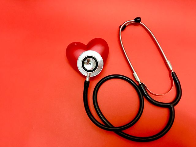 stethoscope  on red heart sing object on red background