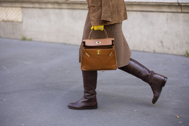 paris, france   march 05 a guest wearing a yellow printed top, brown suede blazer, brown midi skirt, brown boots and camel hermes bag, is seen outside hermes, during paris fashion week   womenswear fw 2022 2023 on march 05, 2022 in paris, france photo by claudio laveniagetty images
