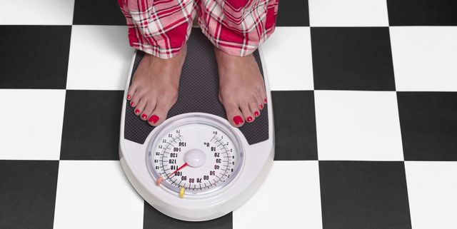 15 stone overweight woman on bathroom scales